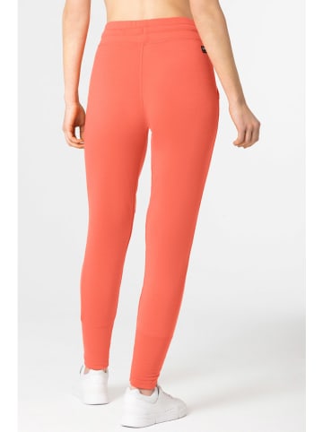 super.natural Spodnie dresowe "Essential" w kolorze pomarańczowym