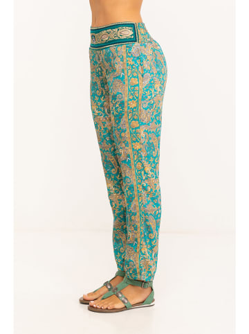 Peace & Love Spodnie w kolorze turkusowym