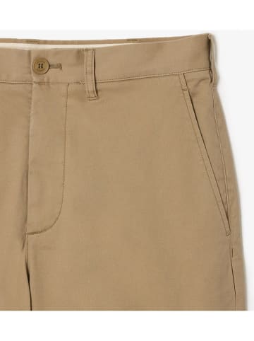 Lacoste Spodnie chino w kolorze beżowym
