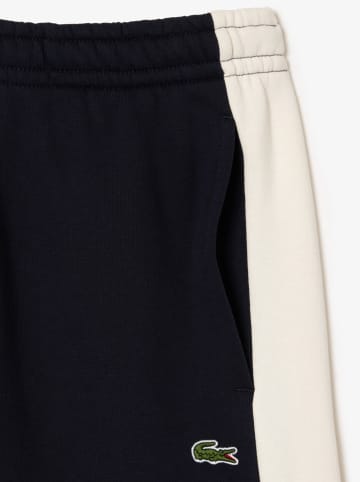 Lacoste Spodnie sportowe w kolorze granatowo-kremowym