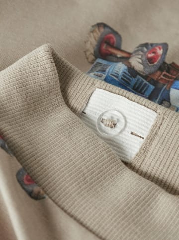 name it Spodnie dresowe w kolorze beżowym ze wzorem