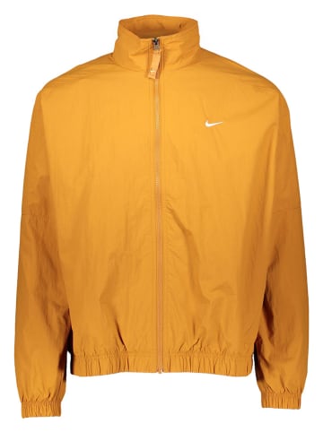 Nike Sportswear Kurtka sportowa "Solo Swoosh Woven" w kolorze pomarańczowym
