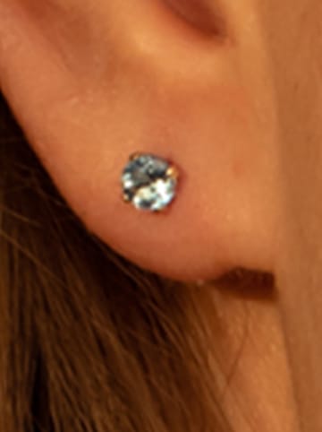 L instant d Or Gouden oorstekers "Puces Topaze bleue" met edelstenen