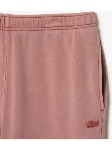 Lacoste Spodnie dresowe w kolorze szaroróżowym