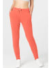 super.natural Spodnie dresowe "Essential" w kolorze pomarańczowym